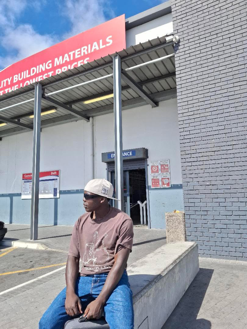 Destiny sitting outside by a building